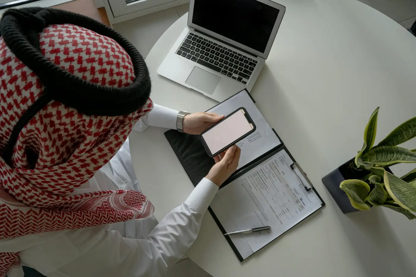 A professional reviewing transaction documents at a desk