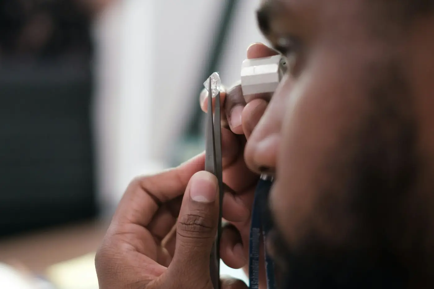 A specialist examining a stone through a loupe